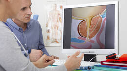Prostatakrebsvorsorge: Patient und Arzt sitzen vor Bildschirm