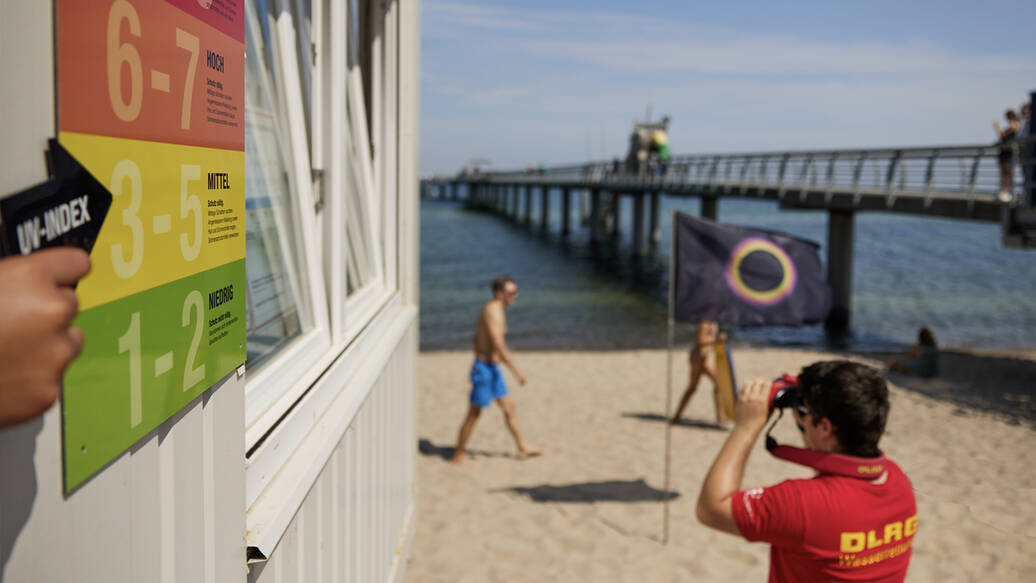Hinweistafel zum UV-Index mit Sun Safety Flag im Hintergrund (Foto: Deutsche Krebshilfe/Heike Rössing)